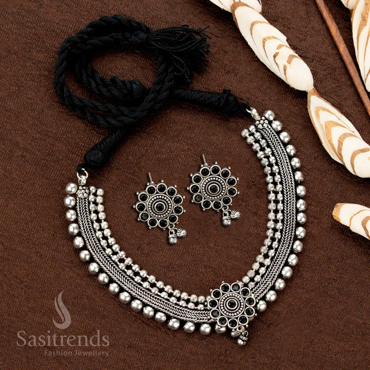 Stylish oxidised choker set with black stone floral motif and earrings, designed with four ball layers—a boho chic Indian jewellery ensemble for bold styling - Sasitrends