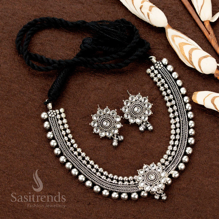 Oxidised German silver choker set with white stone floral pendant, four ball lines, and matching earrings—subtle yet classic jewellery for understated elegance - Sasitrends