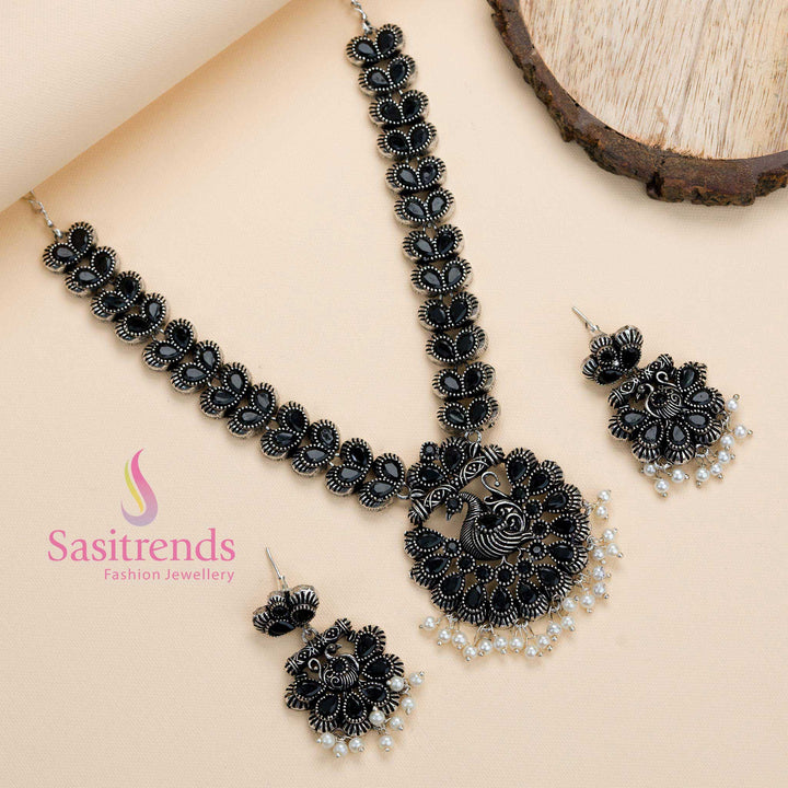 Oxidised silver black stone studded peacock pendant jewellery set with pearl accents and matching earrings, radiating traditional party elegance and classic charm – Sasitrends