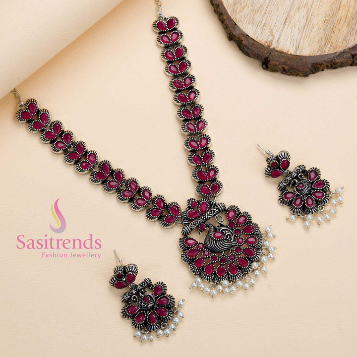Oxidised ruby stone peacock pendant set paired with lustrous pearls and earrings, a festive-glam creation with a touch of ethnic tradition – Sasitrends