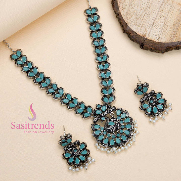 Oxidised peacock pendant set with mint stones and pearl hangings, showcasing soothing elegance in a festive jewellery style – Sasitrends