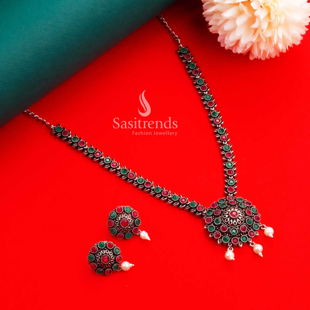 Navarathiri heritage-style oxidised silver floral necklace and earring jewellery set in ruby-green stones with pearl details, ideal for devotional and temple celebrations – Sasitrends