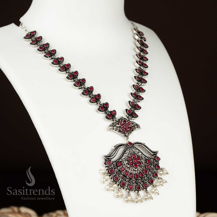 Deep ruby oxidised silver party necklace with elegant flower design and pearl earrings – a vibrant and rich-toned jewellery piece for festive wear by sasitrends