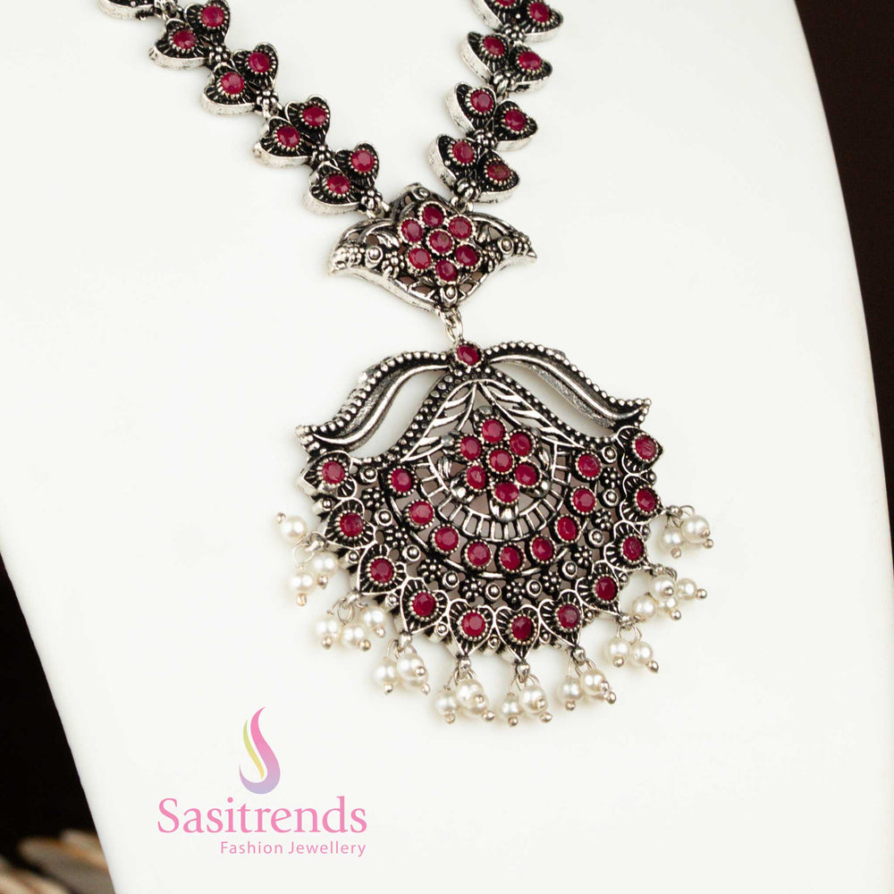 Ruby red oxidised necklace with floral pendant and pearl hangings – a glamorous and bold party jewellery set with traditional richness from sasitrends