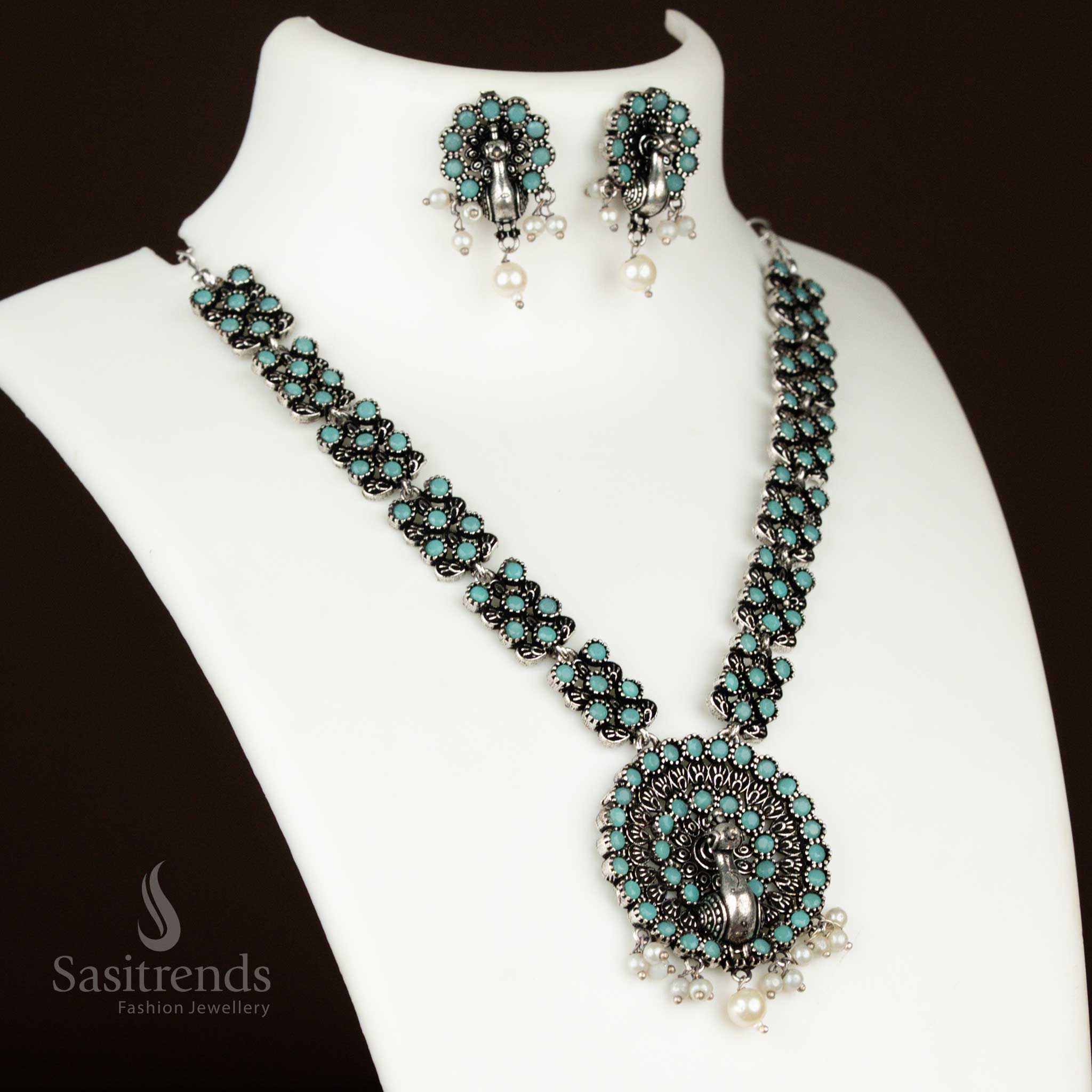 Cool mint oxidised necklace featuring a dancing peacock pendant and pearl earrings – a fresh and refined jewellery set for stylish ethnic celebrations from sasitrends
