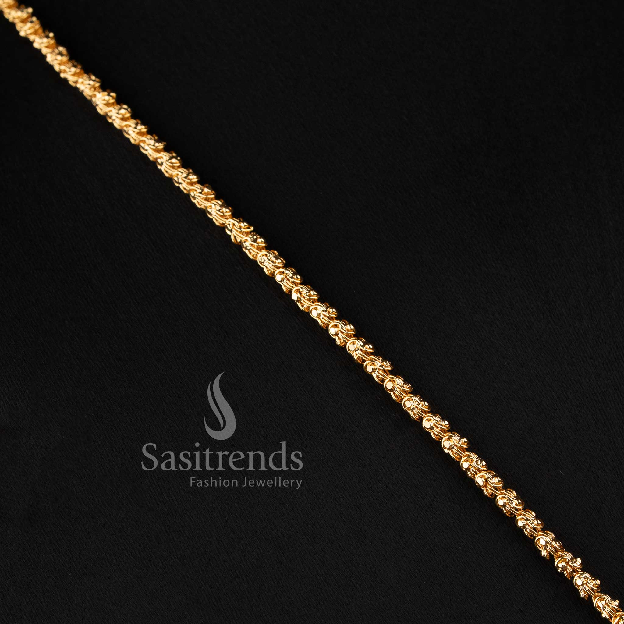 Close-up of an elegant traditional wear interlocking twisted rope chain layout with a stone-studded geometric crest pendant