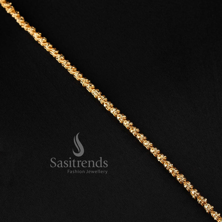 Close-up of an elegant traditional wear interlocking twisted rope chain layout with a stone-studded geometric crest pendant
