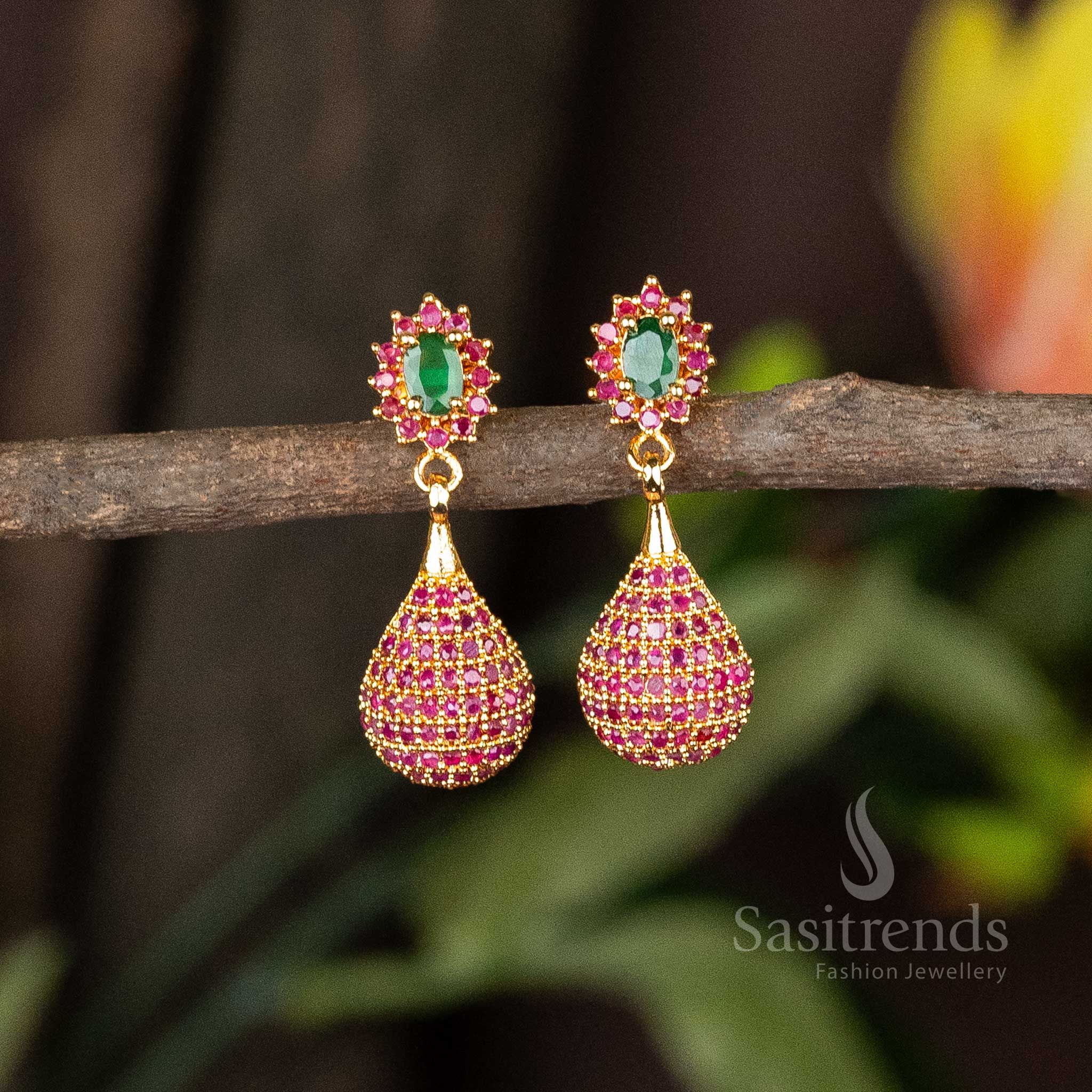 Graceful ruby-green dangler earrings with micro gold finish, embellished with American Diamonds and delicate pearl hangings – A radiant blend of temple heritage and festive charm – Sasitrends