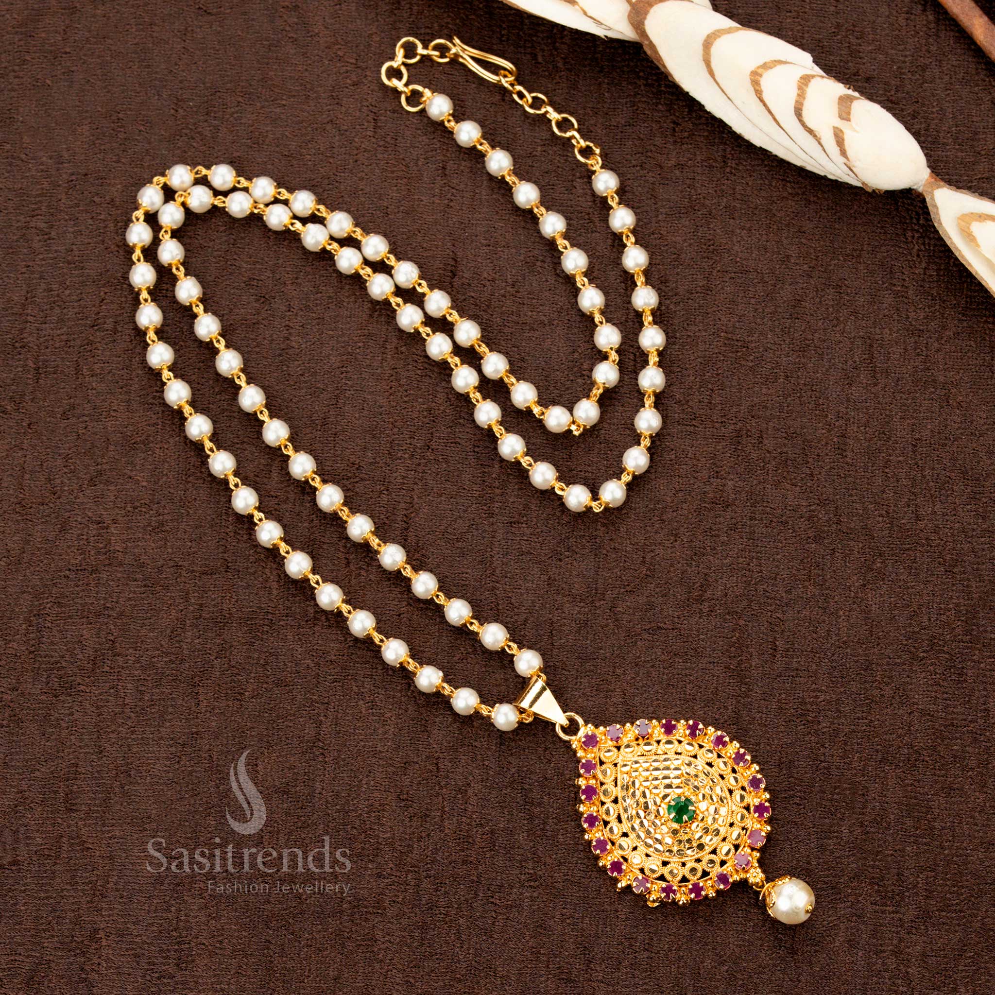 Majestic single-layer pearl mala necklace with a dazzling ruby-green American Diamond pendant, crafted in micro gold plating for an exquisite traditional designer jewellery look - Sasitrends