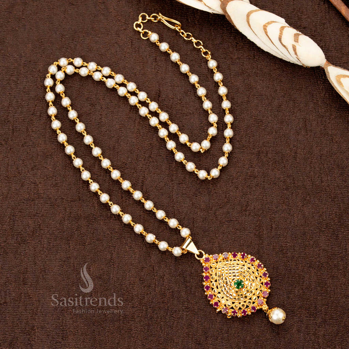 Majestic single-layer pearl mala necklace with a dazzling ruby-green American Diamond pendant, crafted in micro gold plating for an exquisite traditional designer jewellery look - Sasitrends