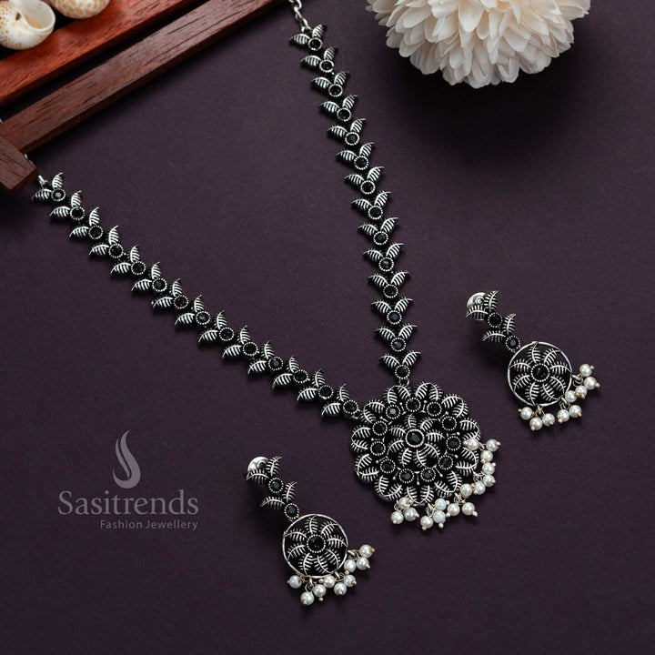 Trendy oxidised silver necklace with black flower-leaf pendant, pearl stones and matching earrings, perfect ethnic jewellery for traditional festivals and special occasions – Sasitrends