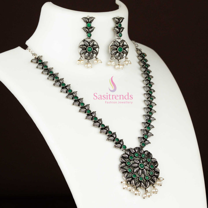 Oxidised silver traditional necklace with green stones, a floral pearl pendant, and matching earrings, perfect for ethnic vintage jewellery styling – Sasitrends