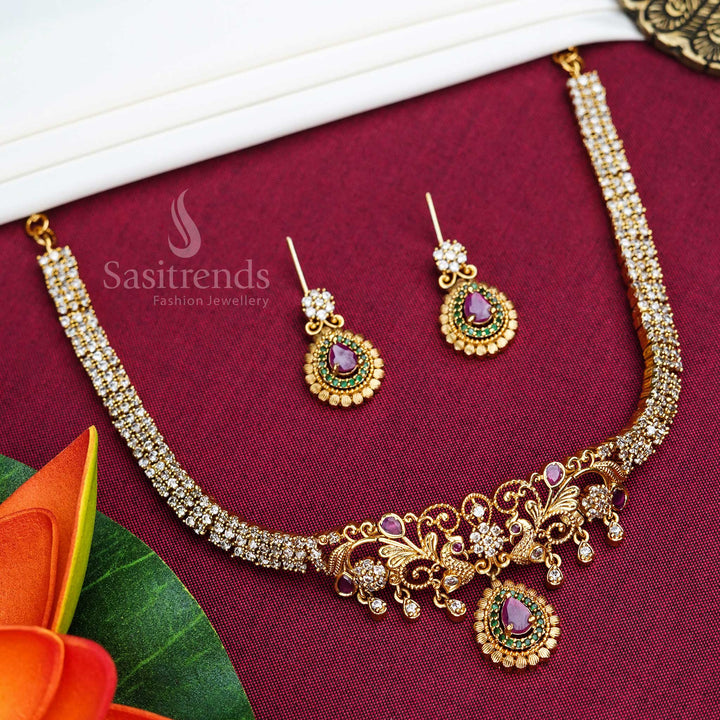 Traditional matte gold plated choker jewellery set featuring intricate peacock and floral carvings, sparkling American Diamonds, and delicate pearl hangings – ideal for wedding elegance – Sasitrends