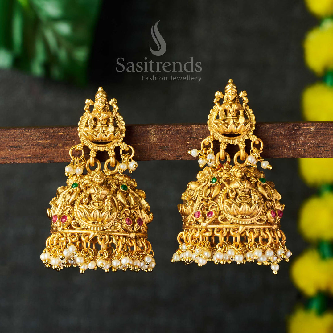 Matte gold plated Lakshmi pearl jhumkas featuring bridal style and temple-inspired beauty with exquisite craftwork, a standout ethnic wedding highlight by Sasitrends