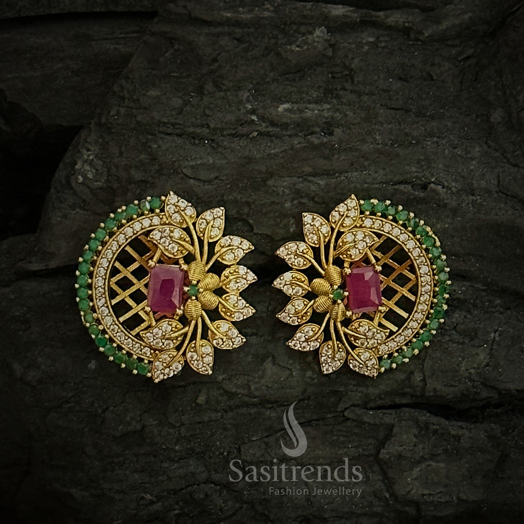 Ornate temple matte gold floral earrings with a centre ruby AD stone and intricate leaf pattern, crafted for a refined cultural jewellery look - Sasitrends