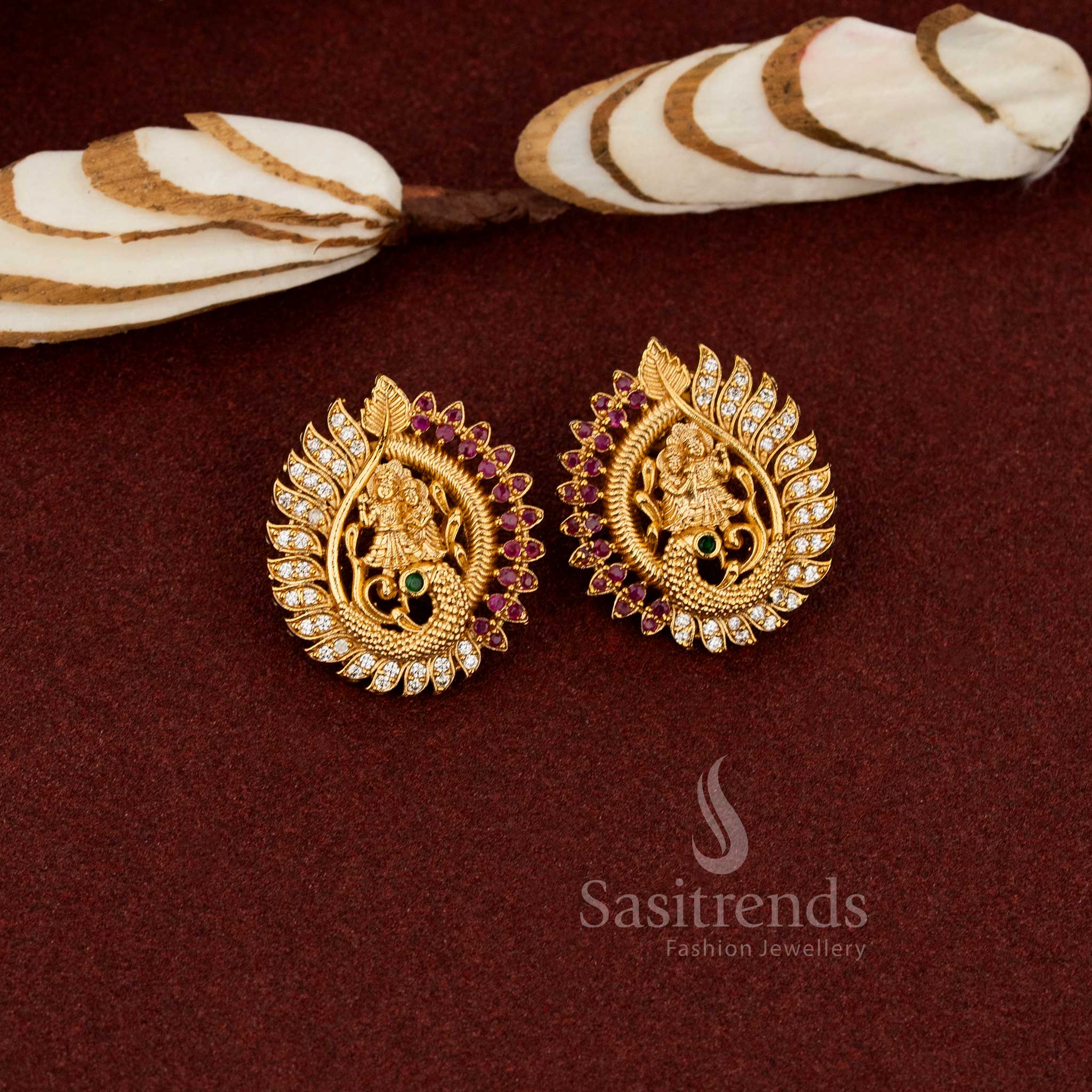 Radha Krishna on peacock temple stud earrings in ruby-white with AD stones, embodying spiritual aura, festive elegance, and temple-crafted brilliance by Sasitrends 