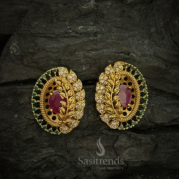 Elegant oval temple matte gold plated stud earrings adorned with a centre ruby stone and delicate AD accents, showcasing refined cultural jewellery style - Sasitrends