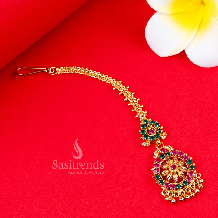 Stunning royal ruby-green dual-tone floral design micro gold plated maang tikka embellished with dazzling AD stones - Sasitrends