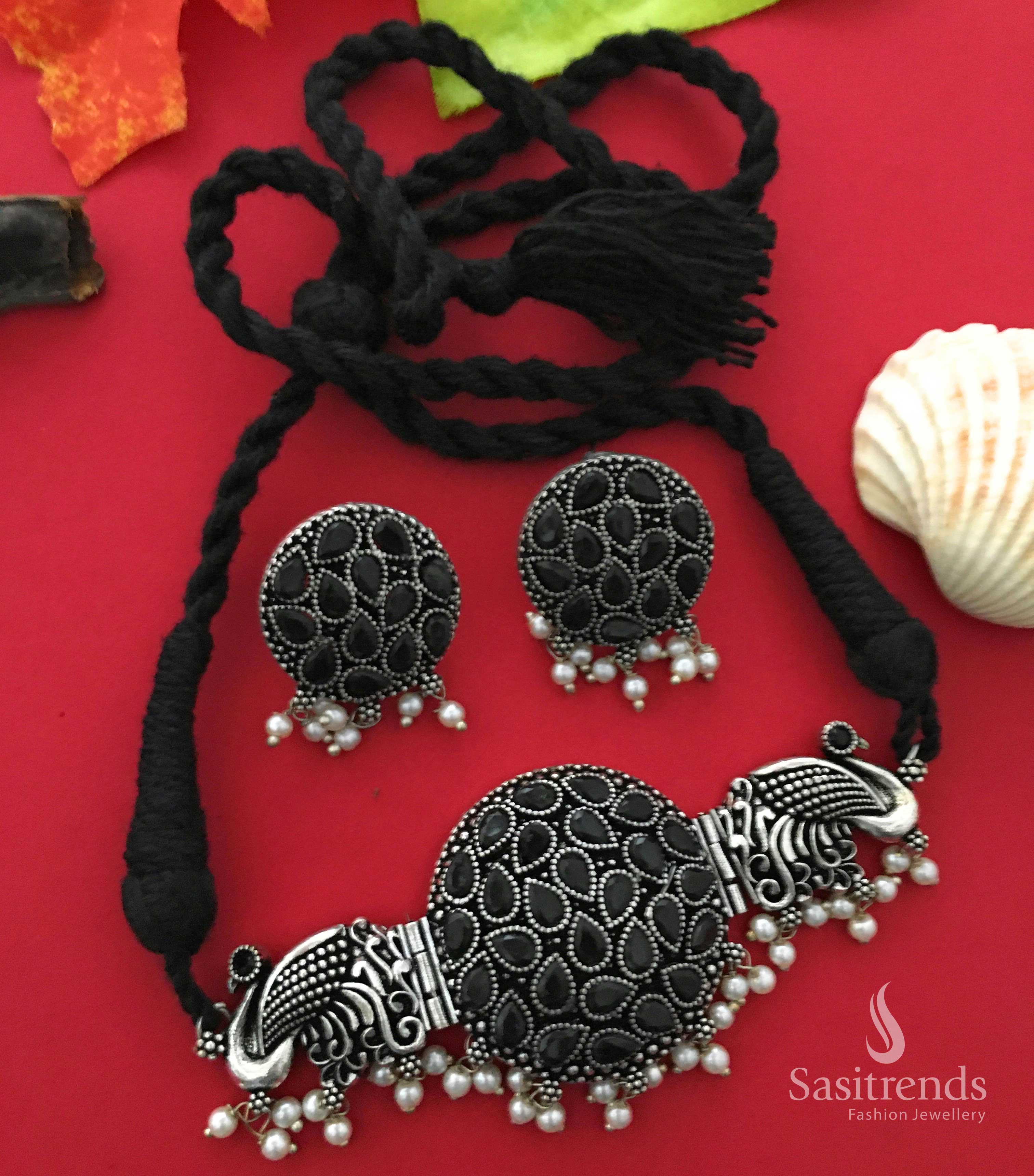 Majestic black peacock design oxidised choker necklace featuring intricate stone work and pearl drops, evoking a vintage tribal charm – Jewellery from Sasitrends


