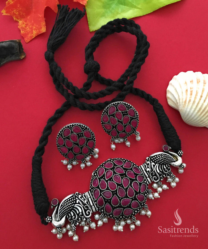 Elegant ruby tone oxidised choker necklace featuring peacock pendant, stone detailing, and pearl jhumkas, reflecting a classic traditional touch – Jewellery from Sasitrends
