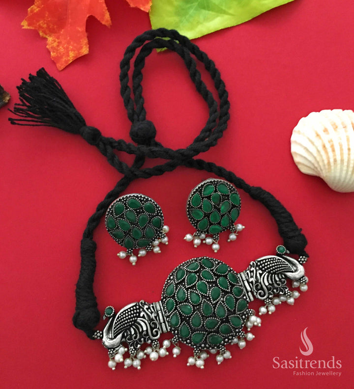 Chic green-toned oxidised choker set with stylised peacock motif, embellished with stones and pearls, making a bold ethnic statement – Jewellery from Sasitrends

