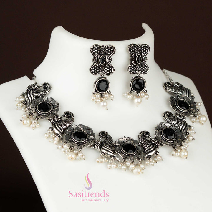 Bold black oxidised jewellery set with a peacock pendant and floral design, finished with pearl hangings for a tribal-chic occasion wear style – Sasitrends