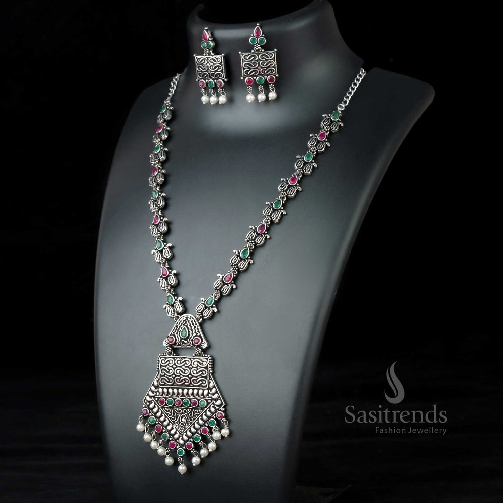 Bold Ruby-Green Tribal Pendant Necklace in oxidised German silver, adorned with glowing stones and classic pearls – Grand cultural jewellery by Sasitrends