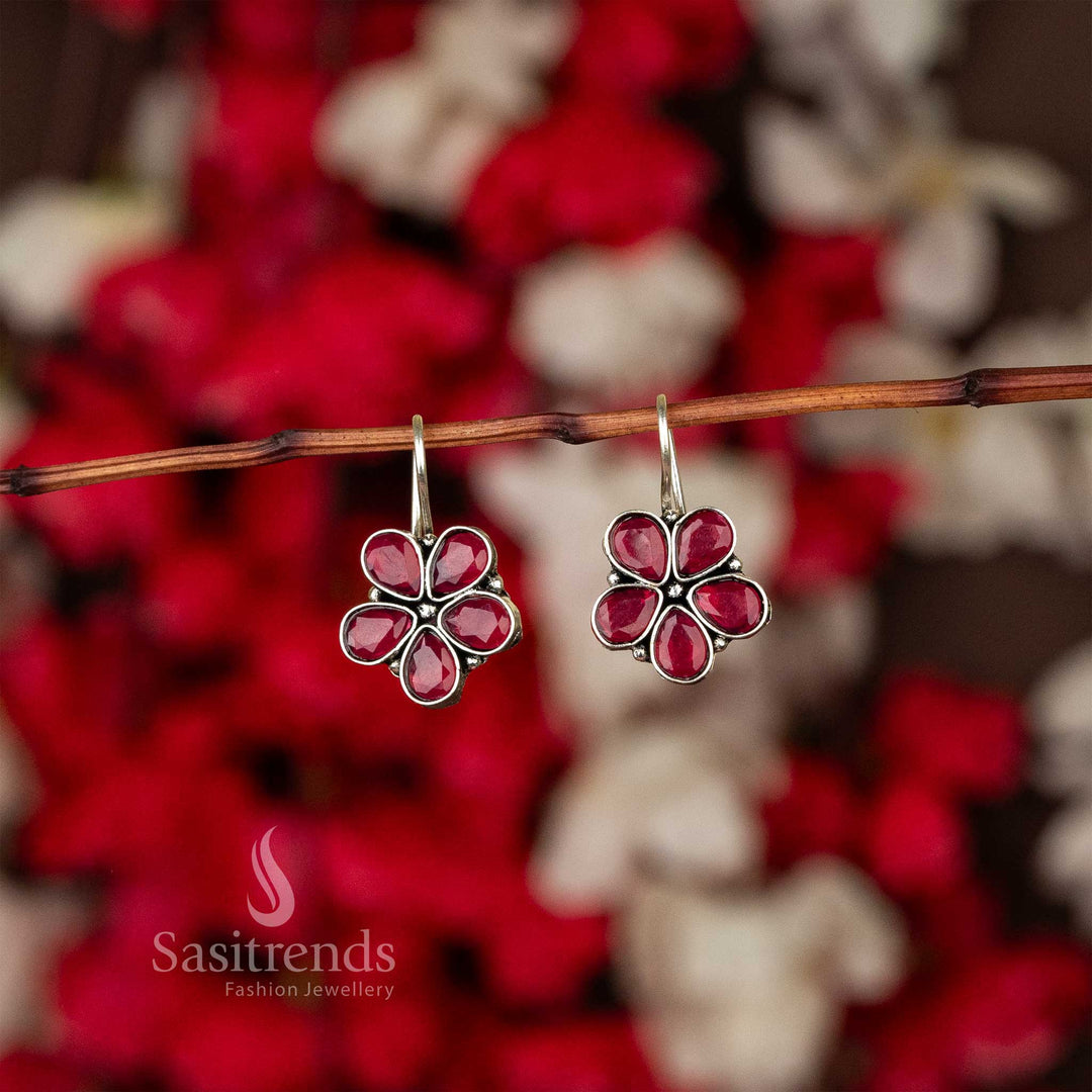 Oxidised petal-shaped earrings with ruby stone accents on fishhook backs navarathiri elegance
