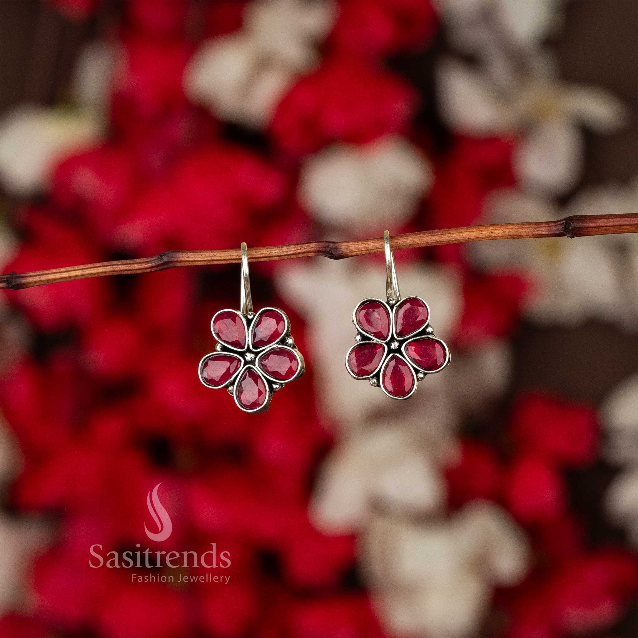 Oxidised petal-shaped earrings with ruby stone accents on fishhook backs navarathiri elegance