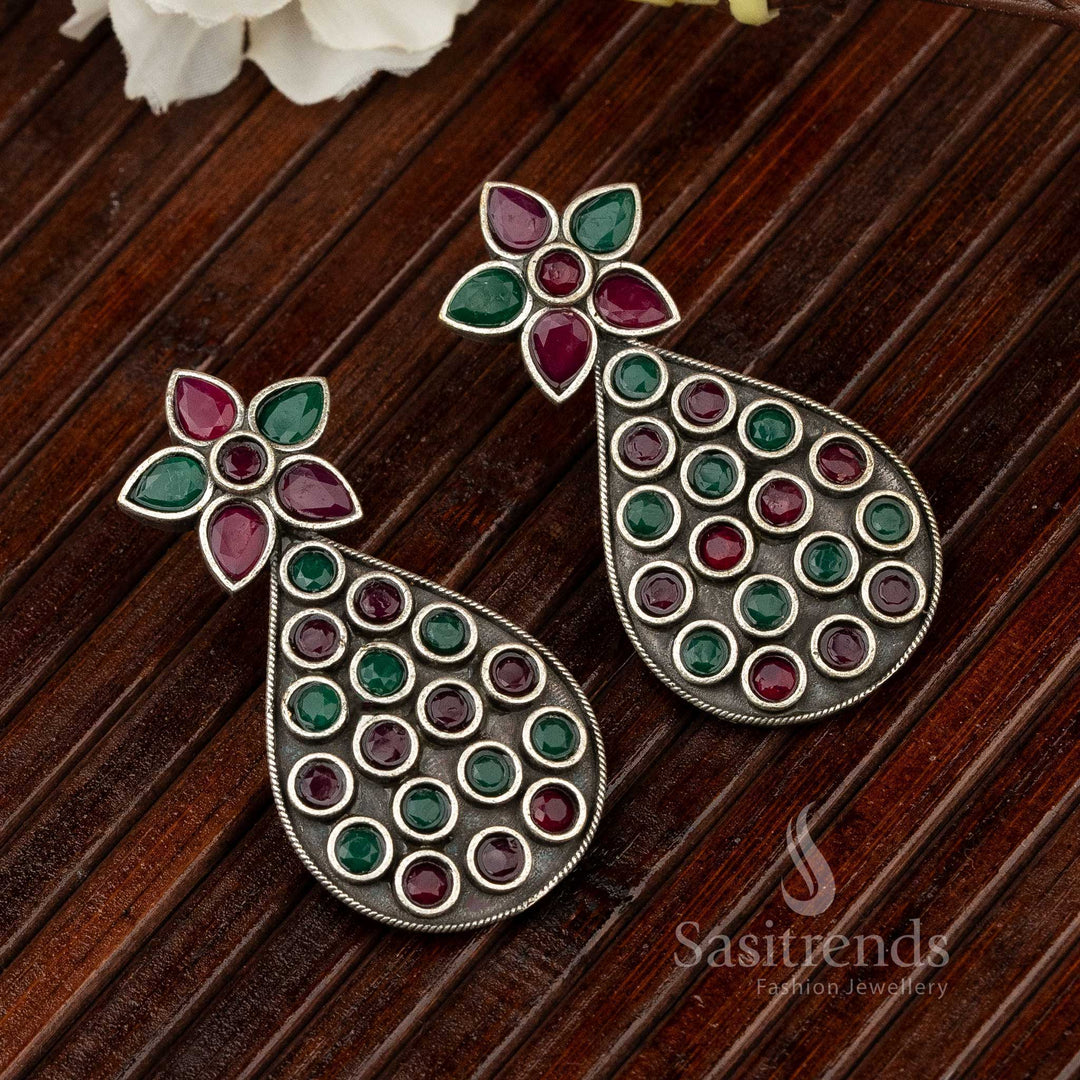 Elegant pear-shaped oxidised German silver ruby-green gemstone earrings featuring dual-tone sparkle with antique floral design – perfect for festive and temple jewellery lovers – Sasitrends
