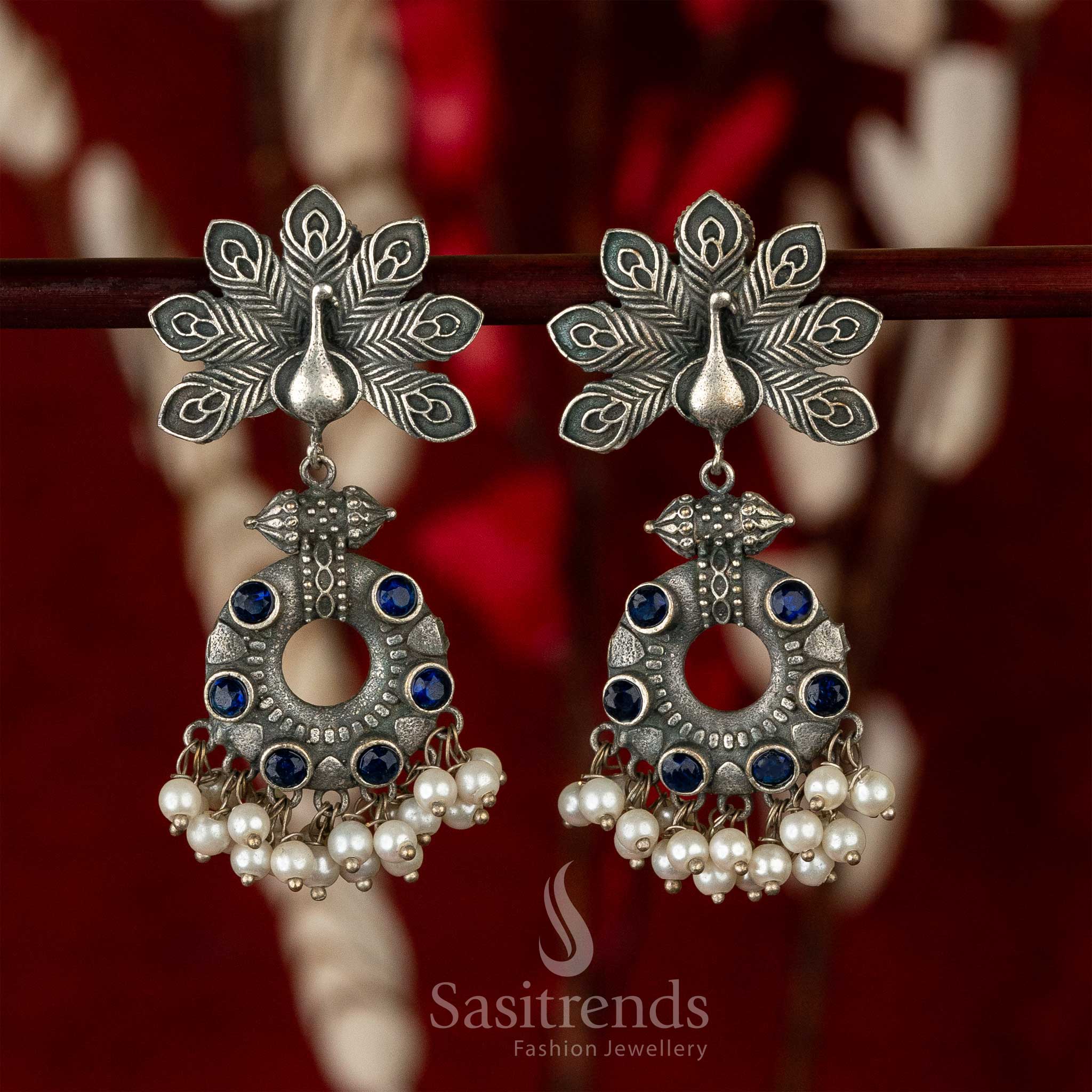 Elegant oxidised earrings with peacock motif, blue gemstone shimmer and pearl hangings – radiating earthy traditional jewellery elegance – Sasitrends