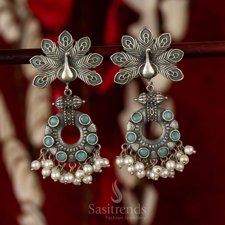Refreshing mint peacock motif earrings in oxidised silver with classic pearl endings and subtle floral touch – a graceful ethnic jewellery piece – Sasitrends