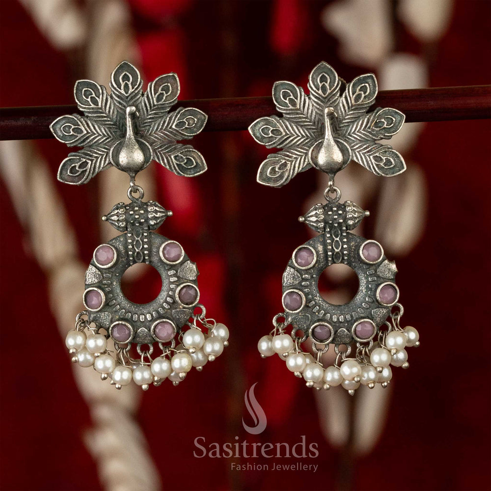 Chic oxidised peacock feather earrings with purple stone centrepiece and drop pearls – a graceful fusion jewellery touch for special celebrations – Sasitrends
