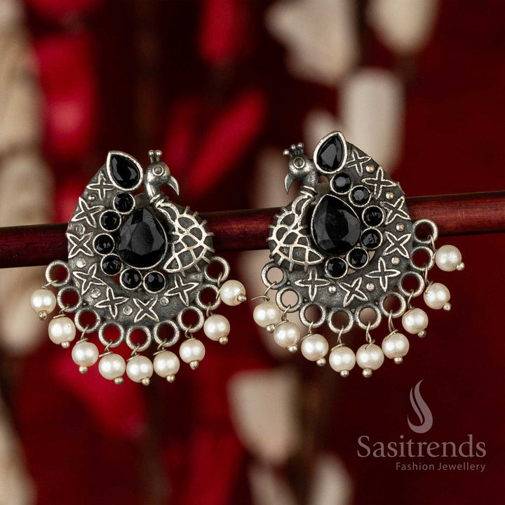 Bold oxidised peacock earrings with dramatic black waterdrop centre stone and artistic feather wings – exuding ethnic chic jewellery vibes – Sasitrends