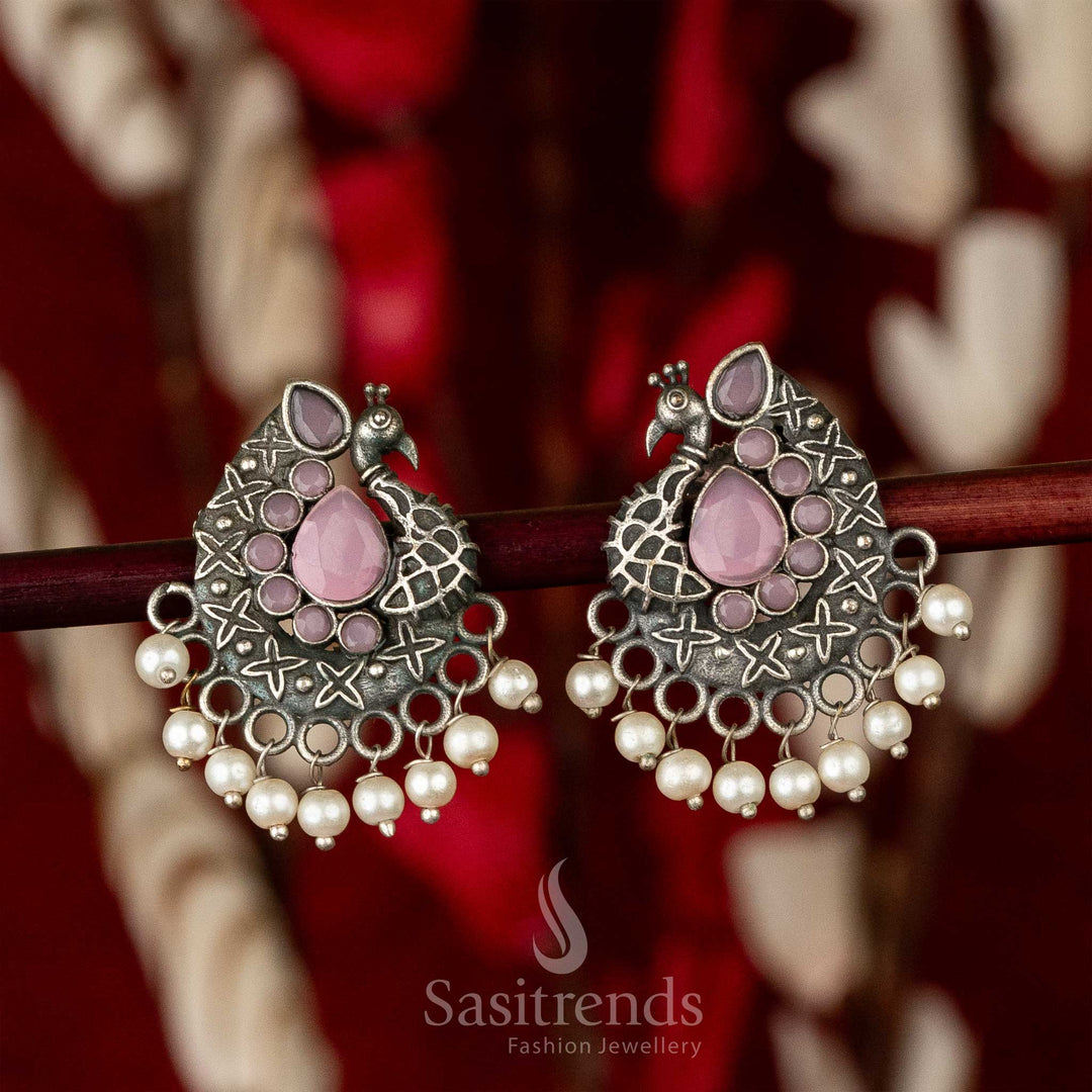 Oxidised silver earrings with elegant pink waterdrop gemstone, peacock motif and layered feather detailing – a stunning piece of fusion jewellery – Sasitrends