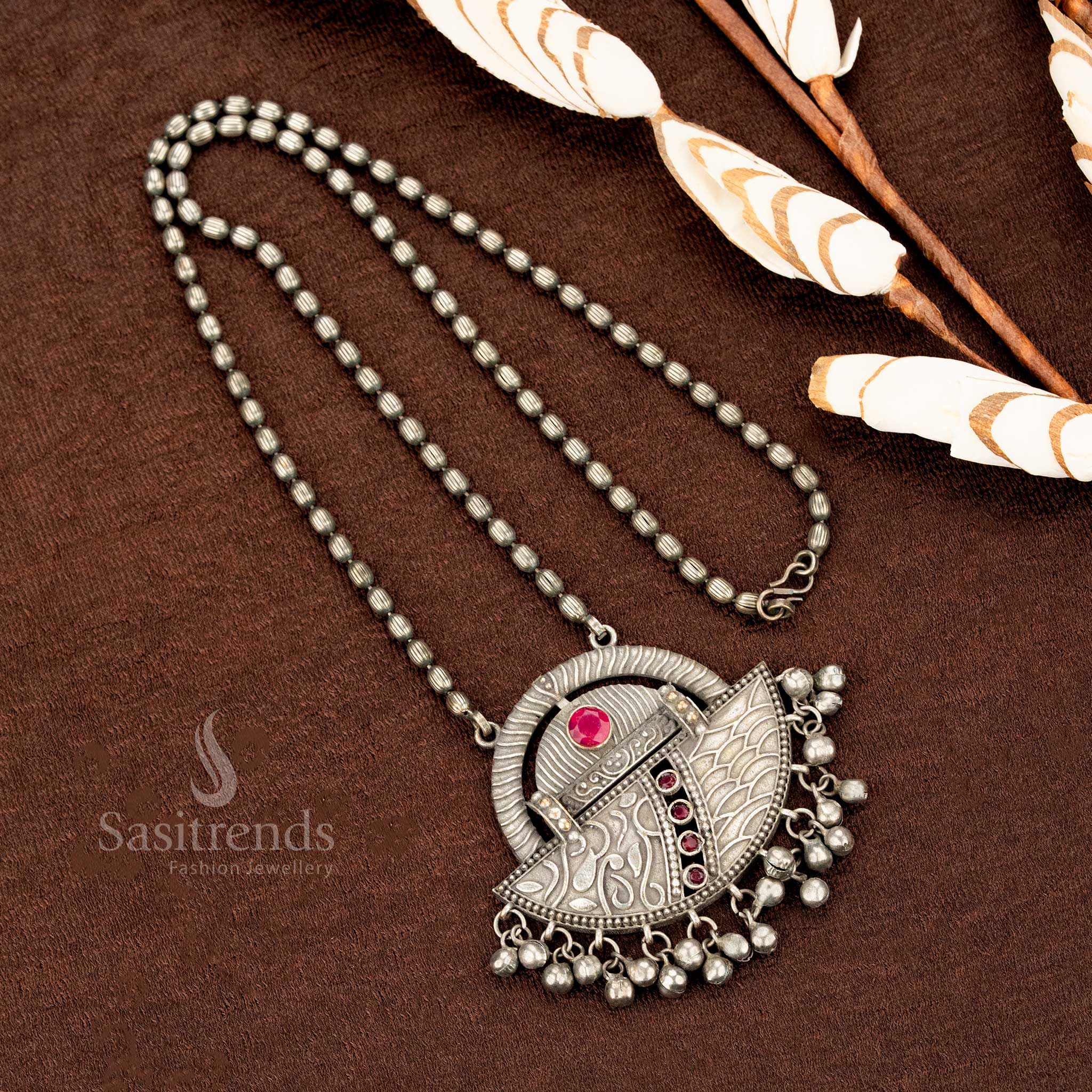 Boho-chic oxidised German silver necklace with deep ruby stone, vintage engraved detailing, and rustic hanging beads – a statement jewellery design for ethnic elegance by Sasitrends