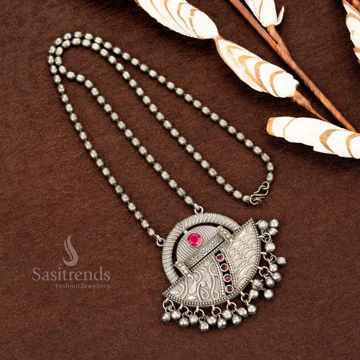 Boho-chic oxidised German silver necklace with deep ruby stone, vintage engraved detailing, and rustic hanging beads – a statement jewellery design for ethnic elegance by Sasitrends