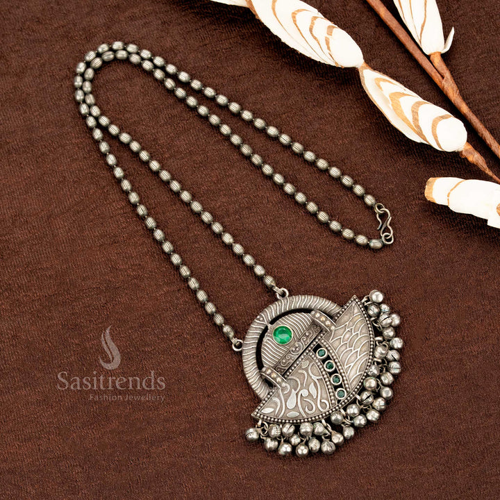 Heritage-inspired oxidised German silver necklace featuring a deep green stone pendant with ethnic engraved details and dainty beaded hangings – an elegant piece of Indian traditional jewellery by Sasitrends