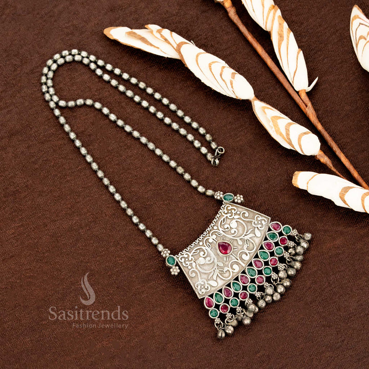 Traditional oxidised necklace with floral engravings and ruby-green stones, capturing tribal artistry for ethnic functions – Sasitrends jewellery
