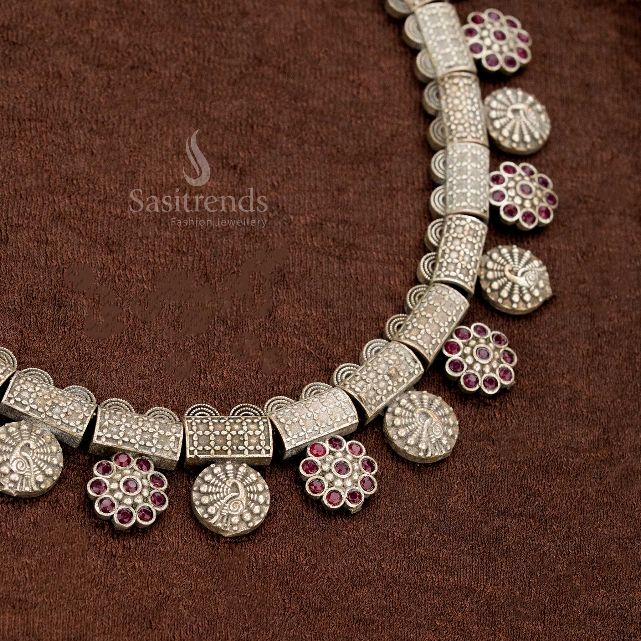 Ruby ethnic style oxidised German silver necklace with decorative antique blocks, floral hangs, and classic round coin motifs – a festive saree jewellery piece steeped in tradition by Sasitrends