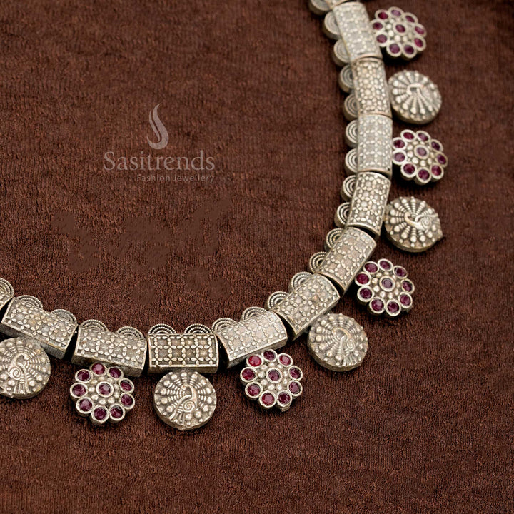 Ruby ethnic style oxidised German silver necklace with decorative antique blocks, floral hangs, and classic round coin motifs – a festive saree jewellery piece steeped in tradition by Sasitrends