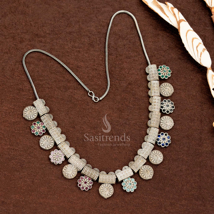 Multi-stone oxidised German silver necklace set with colourful floral hangings, antique block segments, and round studded coin motifs – a vibrant saree jewellery creation by Sasitrends