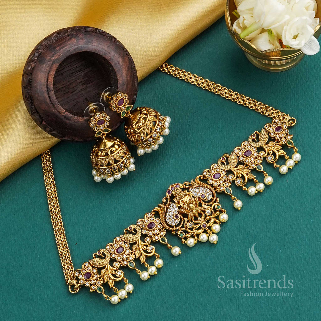 Divinely crafted matte gold plated choker with intricate Lakshmi, peacock, and floral-leaf artistry, accented with embedded AD stones – a stunning traditional choice – Sasitrends
