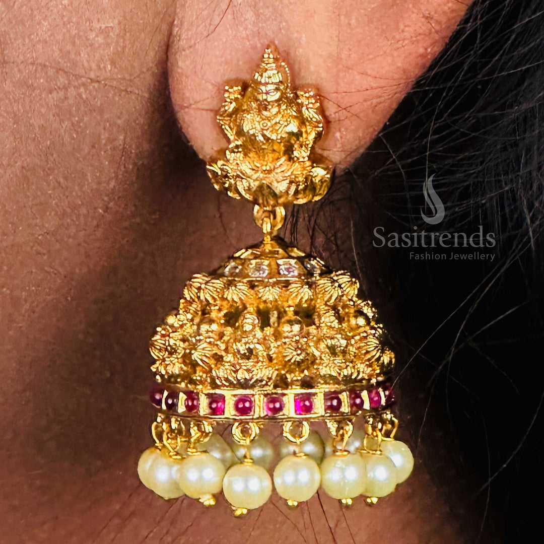 Heritage-inspired pearl embellished matte gold plated temple jhumkas with multi-face Lakshmi idol motif, radiating ethnic bridal jewellery perfection with divine elegance – sasitrends
