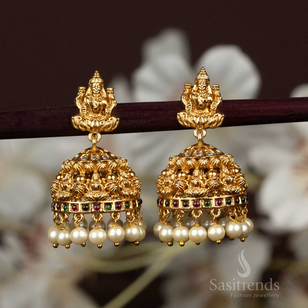 Heritage-inspired pearl embellished matte gold plated temple jhumkas with multi-face Lakshmi idol motif, radiating ethnic bridal jewellery perfection with divine elegance – sasitrends