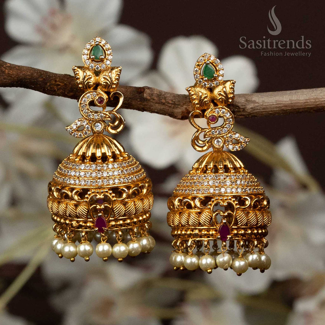 Exquisite temple matte gold finish jhumka earrings with detailed peacock and leaf motifs, adorned with multi-colour stones for traditional jewellery elegance - Sasitrends