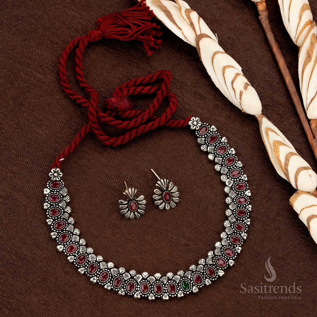 Heritage-inspired oxidised necklace set featuring vibrant ruby oval stones, thread closure, and beautifully matching earrings, crafted for ethnic and wedding wear - Sasitrends