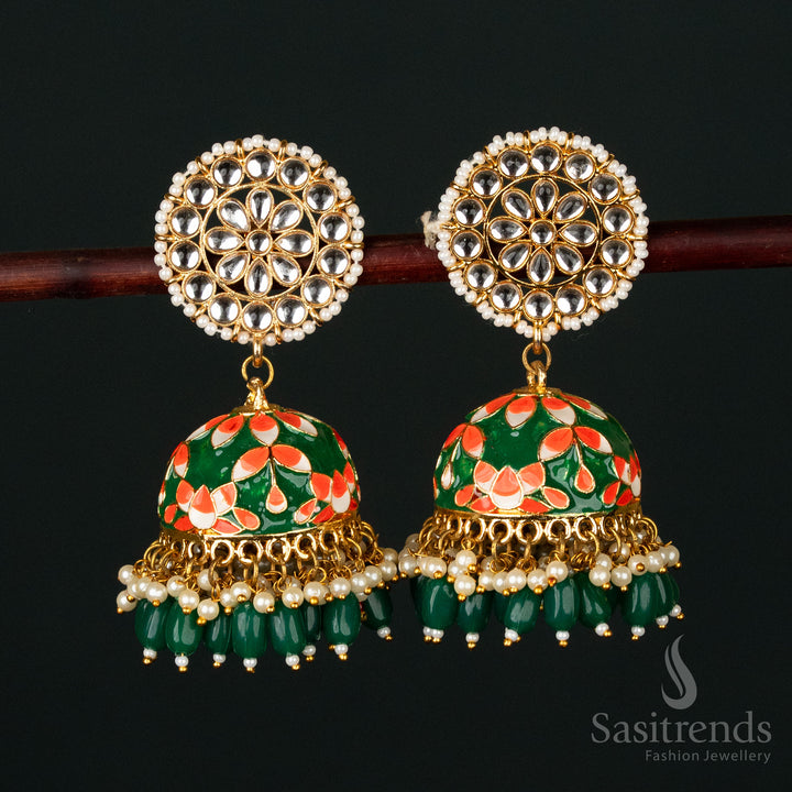 Elegant dark green-orange gold plated pearl jhumka earrings with ornate kundan stone embellishments, an exquisite choice for grand traditional attire - Sasitrends