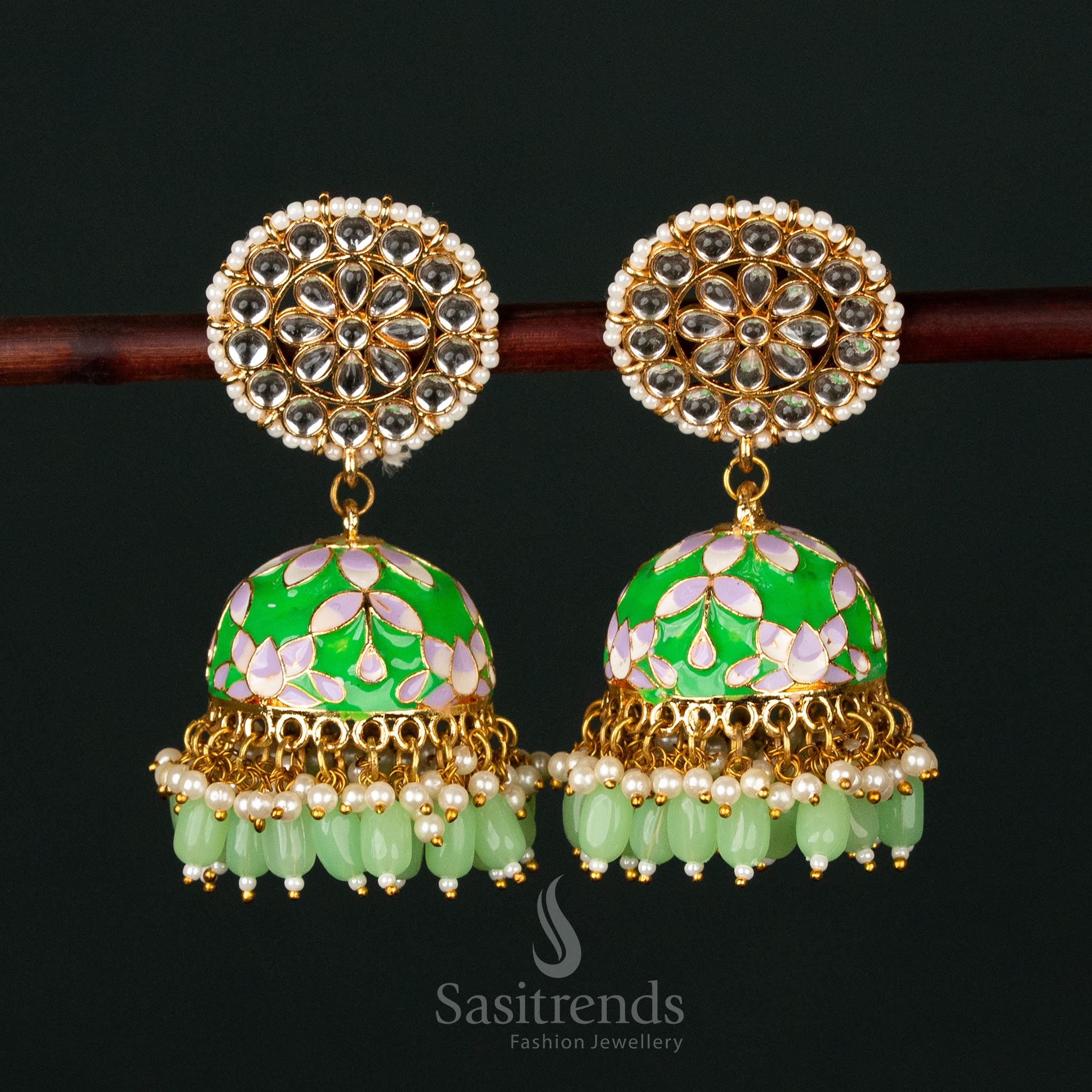 Majestic green-white gold plated pearl jhumka earrings with intricate kundan stone painting, ideal for bridal and festive occasions - Sasitrends