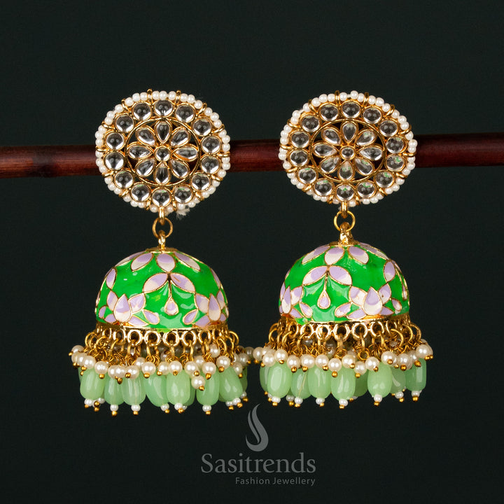 Majestic green-white gold plated pearl jhumka earrings with intricate kundan stone painting, ideal for bridal and festive occasions - Sasitrends